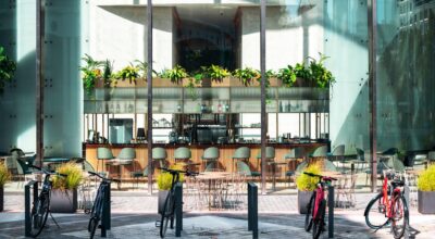 Article about Sustainable Shopping Spaces: A Path to a Greener Future - image of bicycles lined up in front of a stores